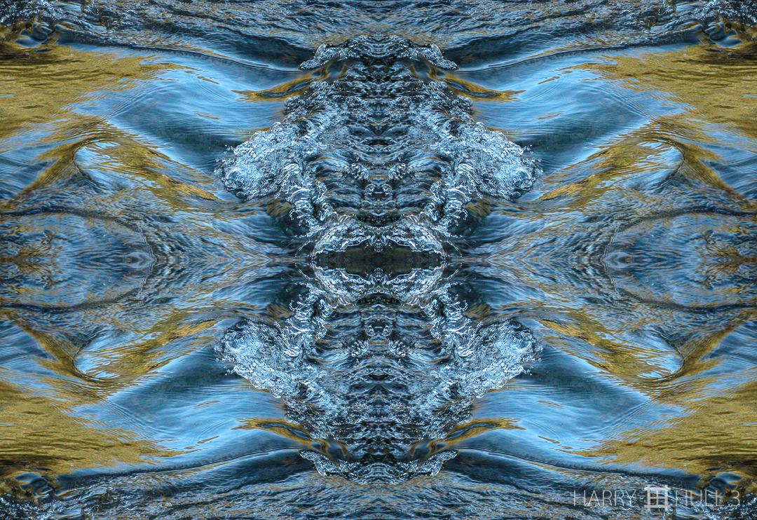 Fluid dynamics: river surface. Photo close-up of water breaking over a shallow rock in the Garcia River, Oz Farm, Point Arena, California.