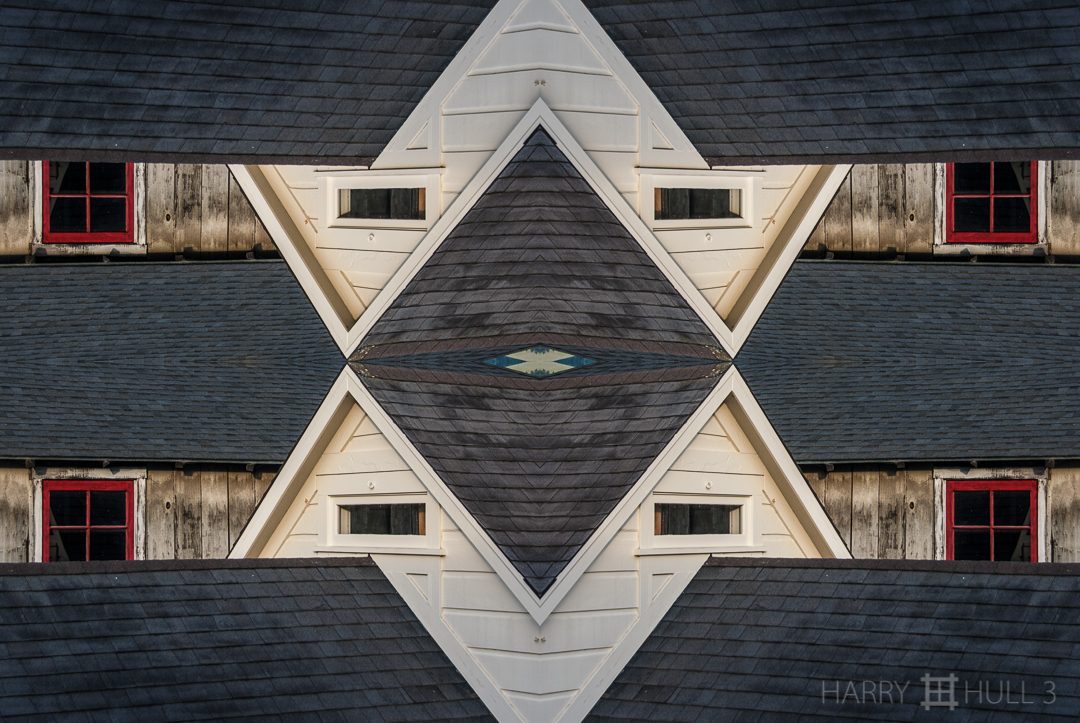 Red window. Photo detail of roof top, window and houses, Bolinas, California.