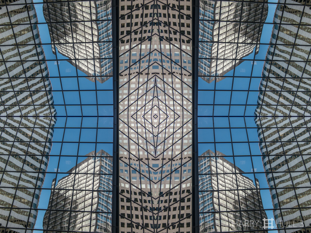 Urban gridlines. Photo of buildings reflected in the facade of an office building in downtown Denver, Colorado.