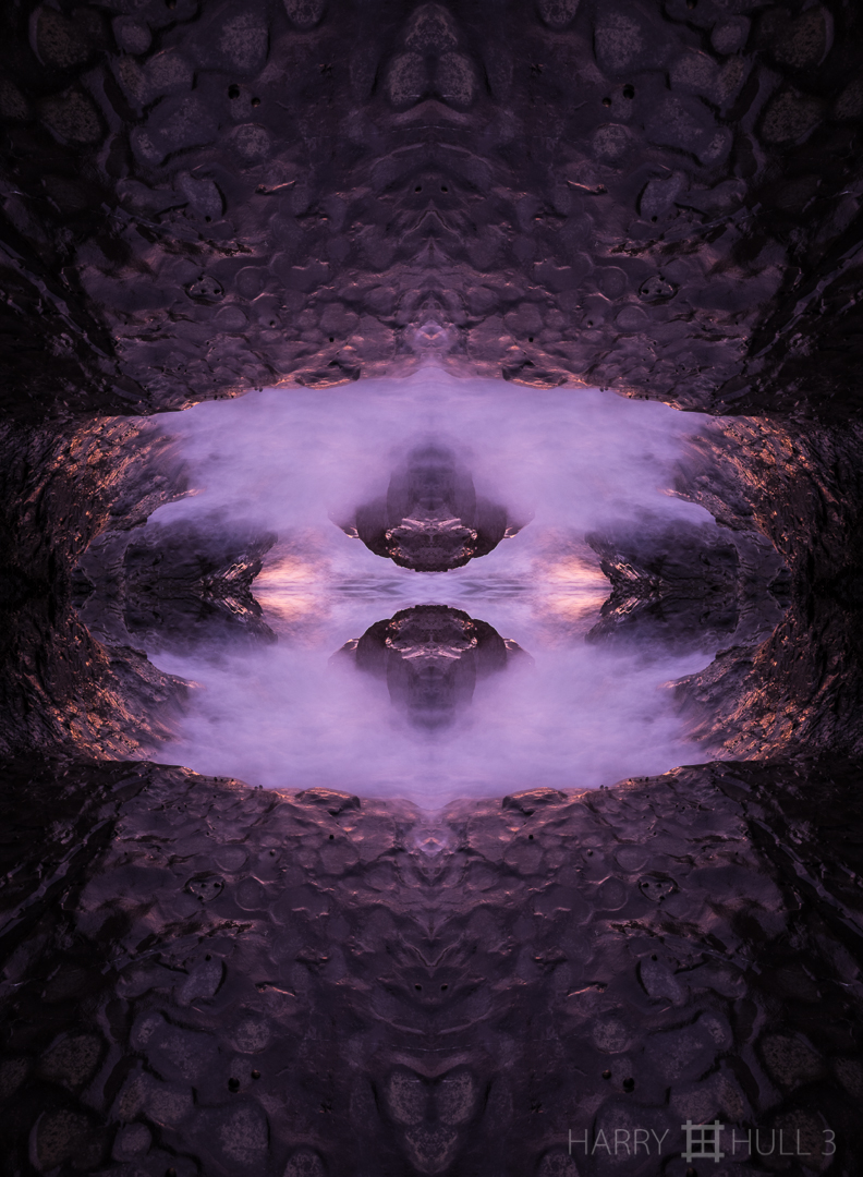 Entrance to the underworld. Photo of ocean wave flowing over shore rock, Playa Santa Teresa, Nicoya Peninsula, Costa Rica.