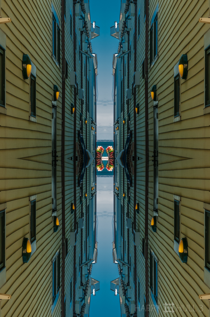Alley to the sea. Photo of alley in Provincetown, Massachusetts with kayaks stacked at the end near the shore.