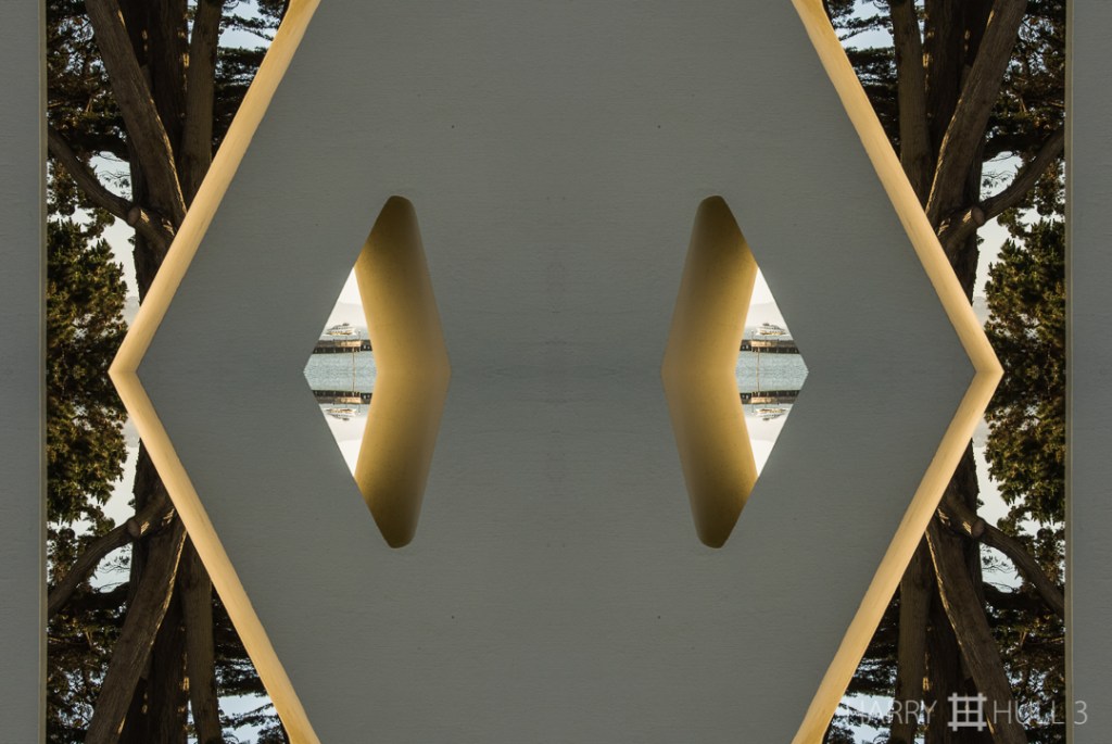 Concrete figure. Photo of base of an observation platform near Aquatic Park, San Francisco, California, with a tour boat on San Francisco Bay in the background.