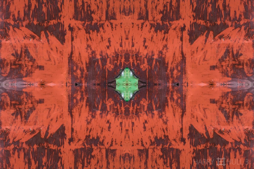 The green beneath. Photo of weathered metal door on a storage shed, with older green door surface showing in a corner, Cerro Punta, Panama.