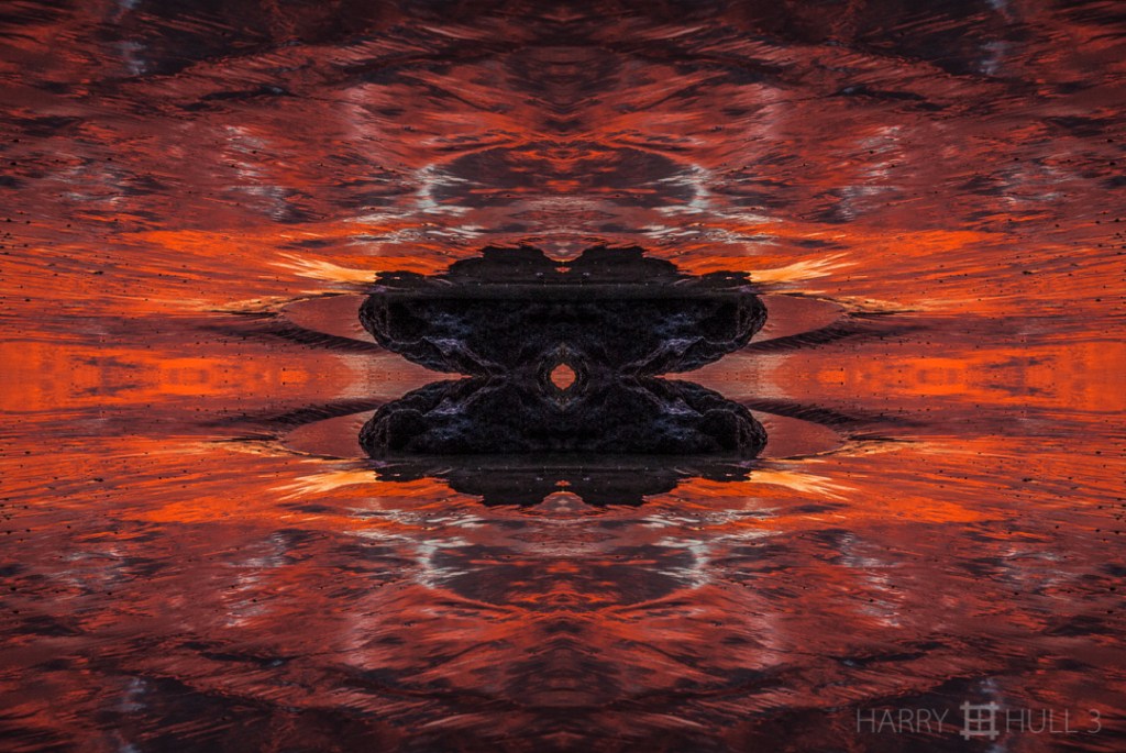 Fire water. Photo of sunset refected in wet sand with rock, Playa Tamarindo, Costa Rica.