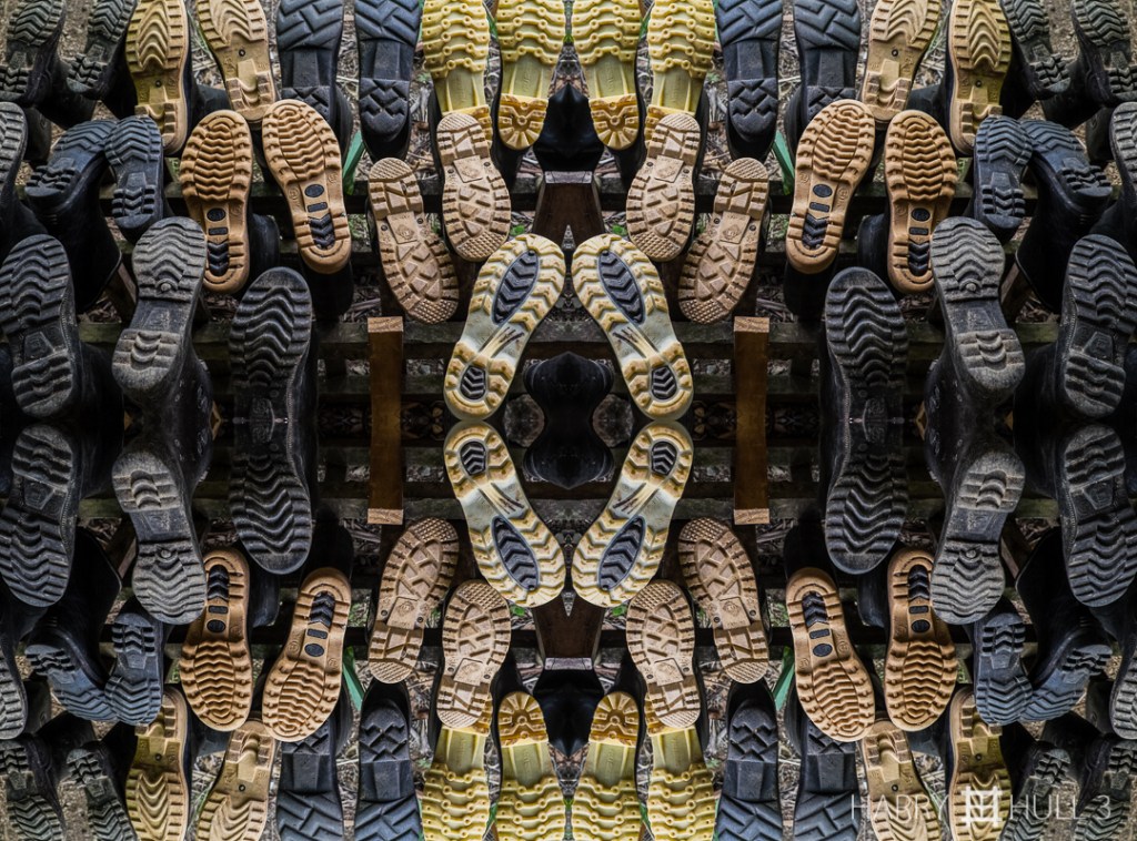 Convocation of soles. Photo of rubber boots for guests on a boot rack in the guide cabin, Lapa Rios Ecolodge, Costa Rica.